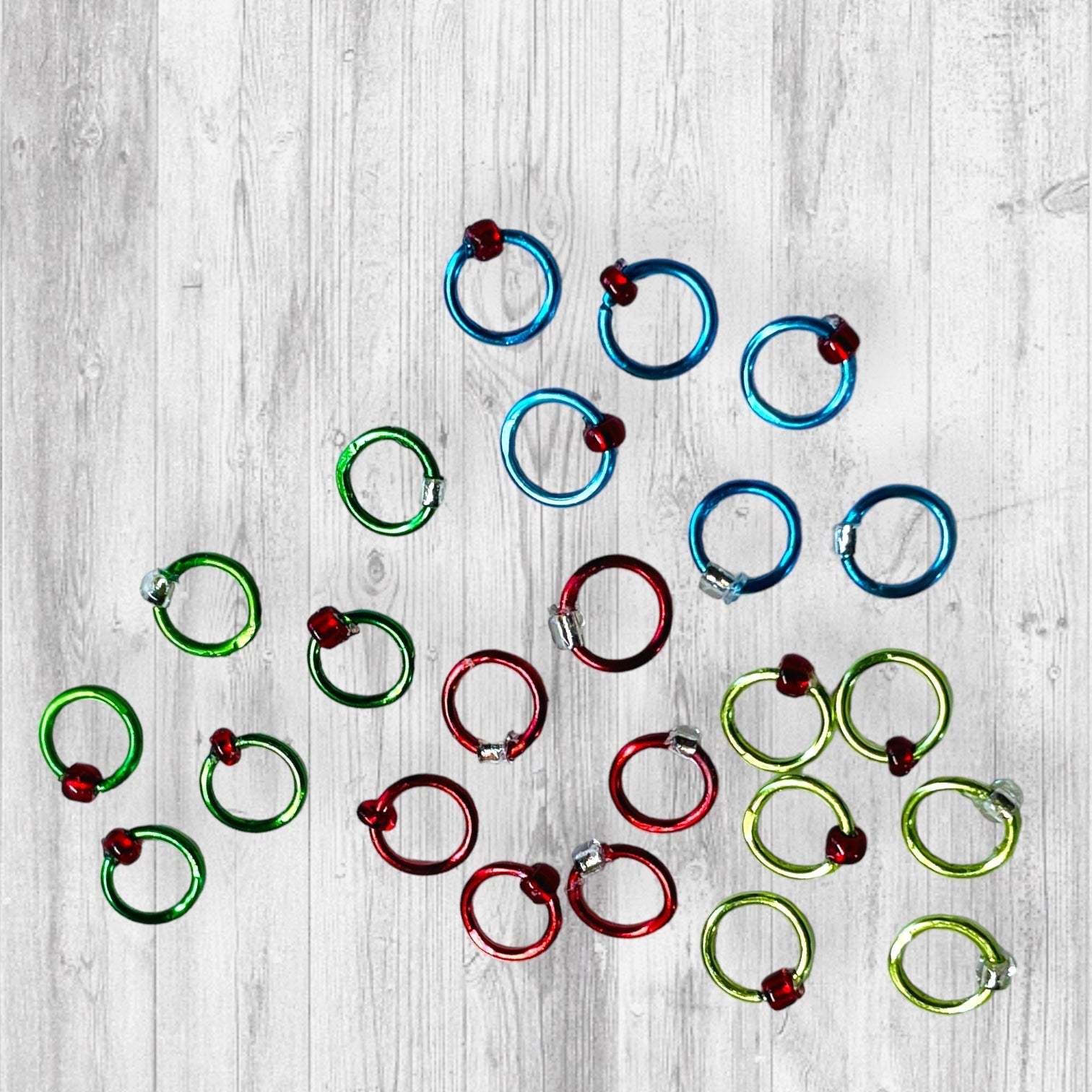 Christmas Sock Knitter's Companion Tiny Stitch Markers with Marker ConAdoreKnitThe Christmas Sock Knitter's Companion!! These tiny stitch markers are perfect for sock knitters. Designed to fit needle sizes: 0-1 US (2-2.5mm). This little set is Companion Tiny Stitch Markers