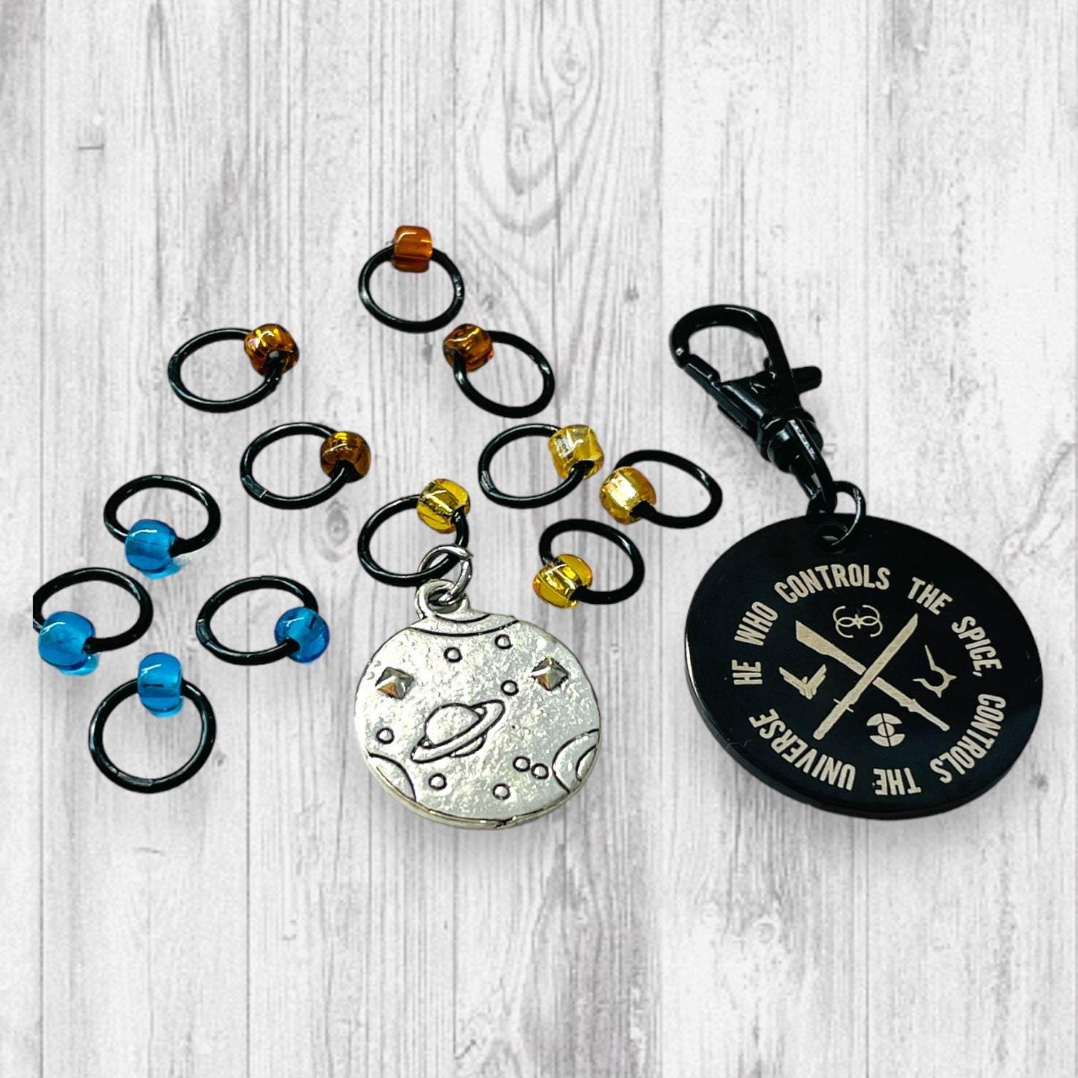 He Who Controls the Spice Progress and Universe Stitch MarkersAdoreKnitHe Who Controls the Spice Progress and Stitch Marker Set.  Inspired by the Frank Herbert's classic novel Dune.  1 of 4 marker sets in the Dune Collection created forUniverse Stitch Markers
