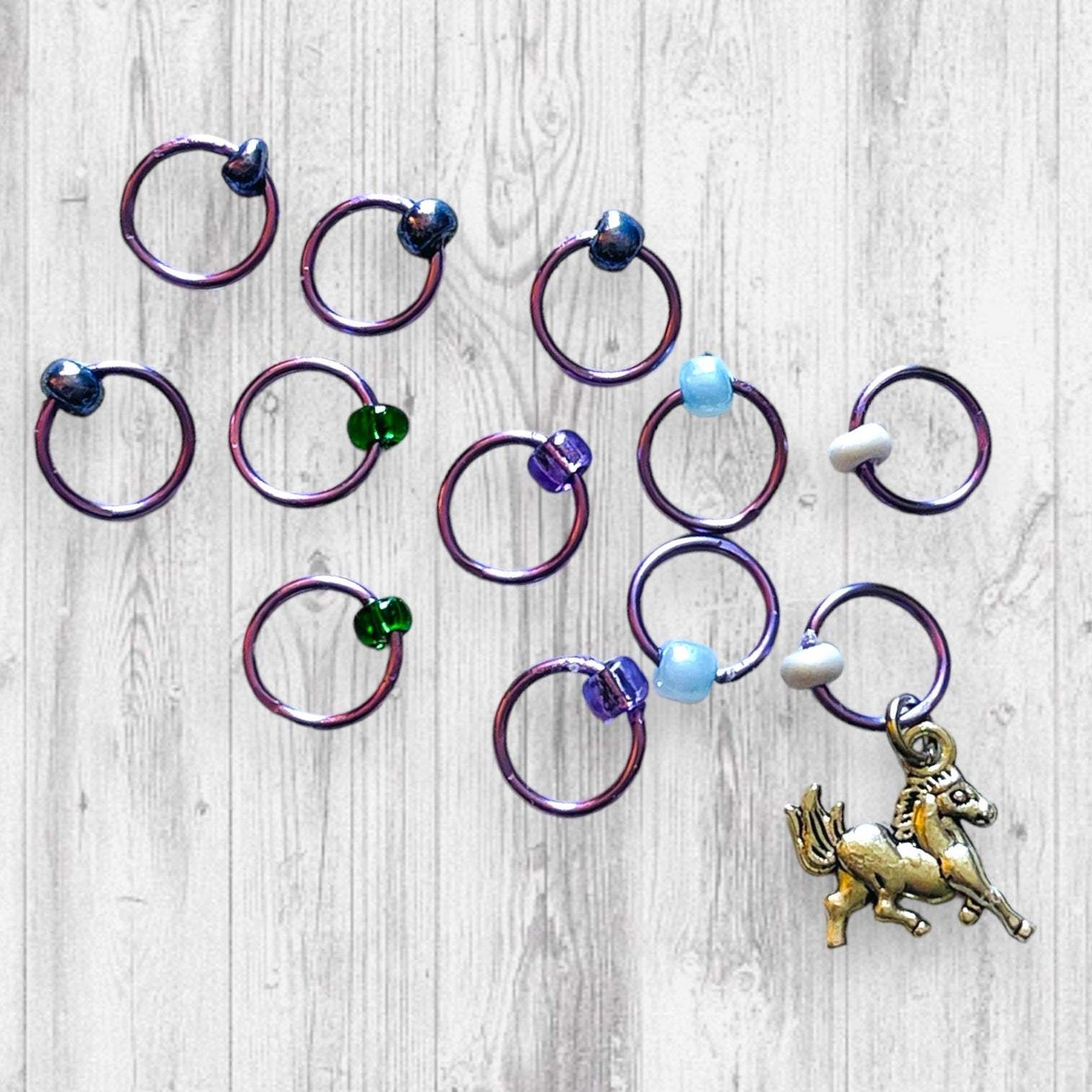 Evenstar inspired Progress and Stitch MarkersAdoreKnitEvenstar inspired Progress and Stitch Markers.   Inspired by the Evenstar worn by Arwen in The Lord of the Rings.  And also inspired by Arwen and Frodo's race on horEvenstar inspired Progress