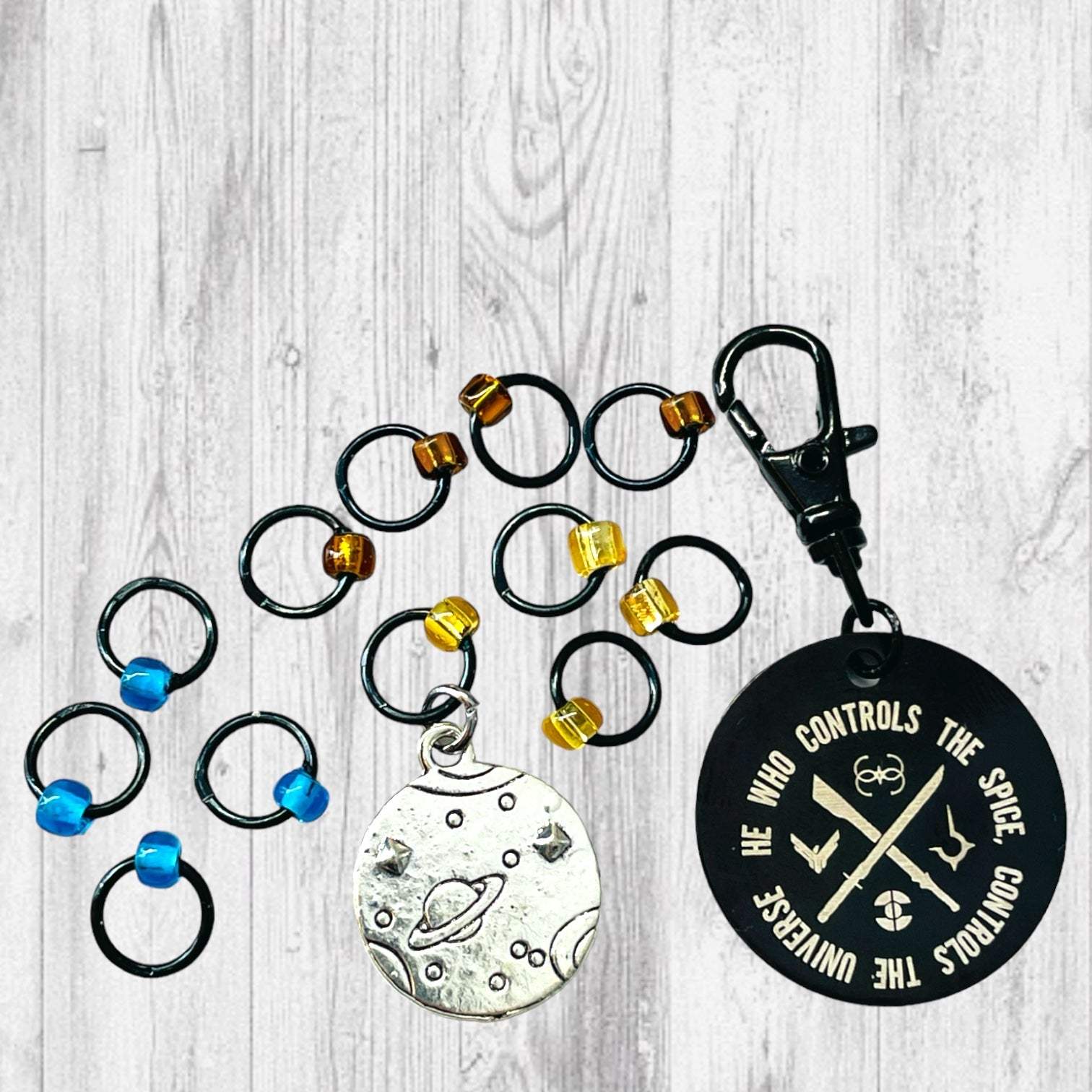 He Who Controls the Spice Progress and Universe Stitch MarkersAdoreKnitHe Who Controls the Spice Progress and Stitch Marker Set.  Inspired by the Frank Herbert's classic novel Dune.  1 of 4 marker sets in the Dune Collection created forUniverse Stitch Markers