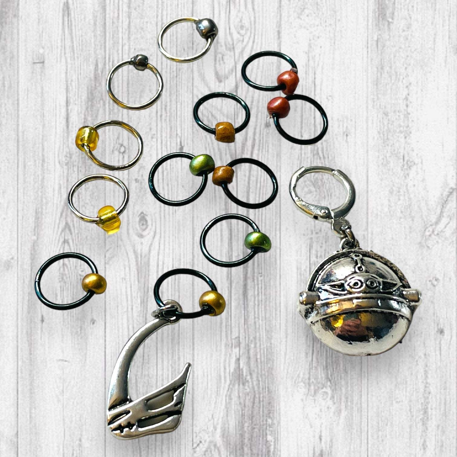 Mudhorn Clan Progress and Stitch MarkersAdoreKnitNext Generation Bounty Hunter Progress and Stitch Markers. Inspired by The Mandalorian, Din Djarin from the Mandalorian Series.  The prefect gift for a knitter! ThesMudhorn Clan Progress