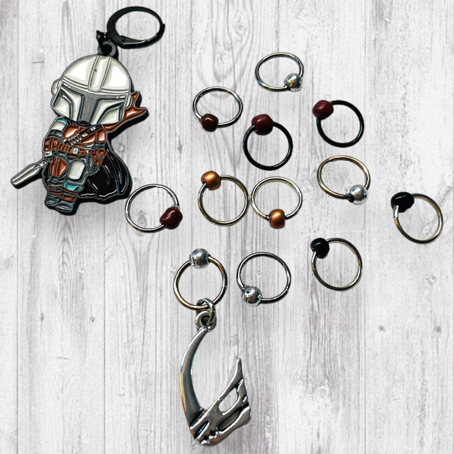 Next Generation Bounty Hunter Progress and Stitch MarkersAdoreKnitNext Generation Bounty Hunter Progress and Stitch Markers. Inspired by The Mandalorian, Din Djarin from the Mandalorian Series.  The prefect gift for a knitter! ThesGeneration Bounty Hunter Progress