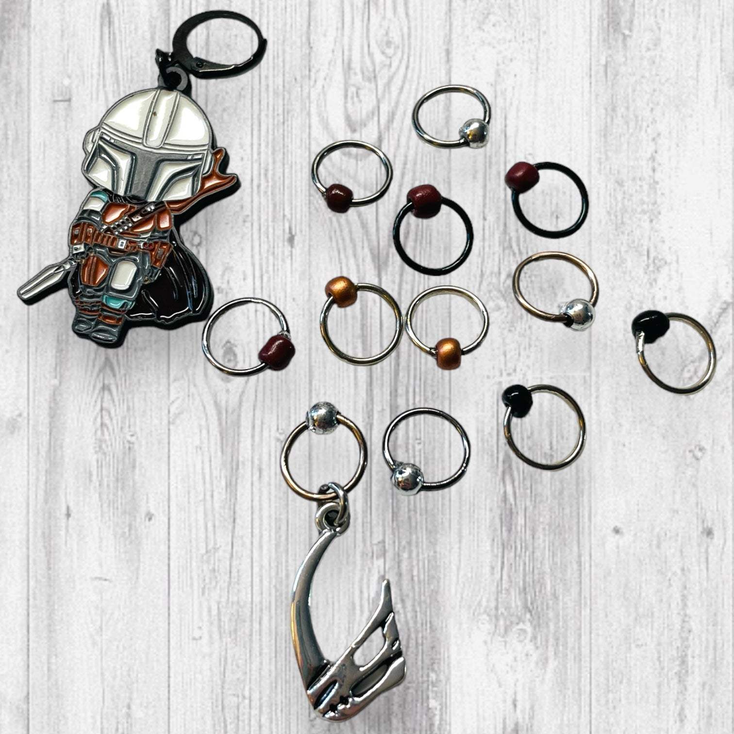 Next Generation Bounty Hunter Progress and Stitch MarkersAdoreKnitNext Generation Bounty Hunter Progress and Stitch Markers. Inspired by The Mandalorian, Din Djarin from the Mandalorian Series.  The prefect gift for a knitter! ThesGeneration Bounty Hunter Progress