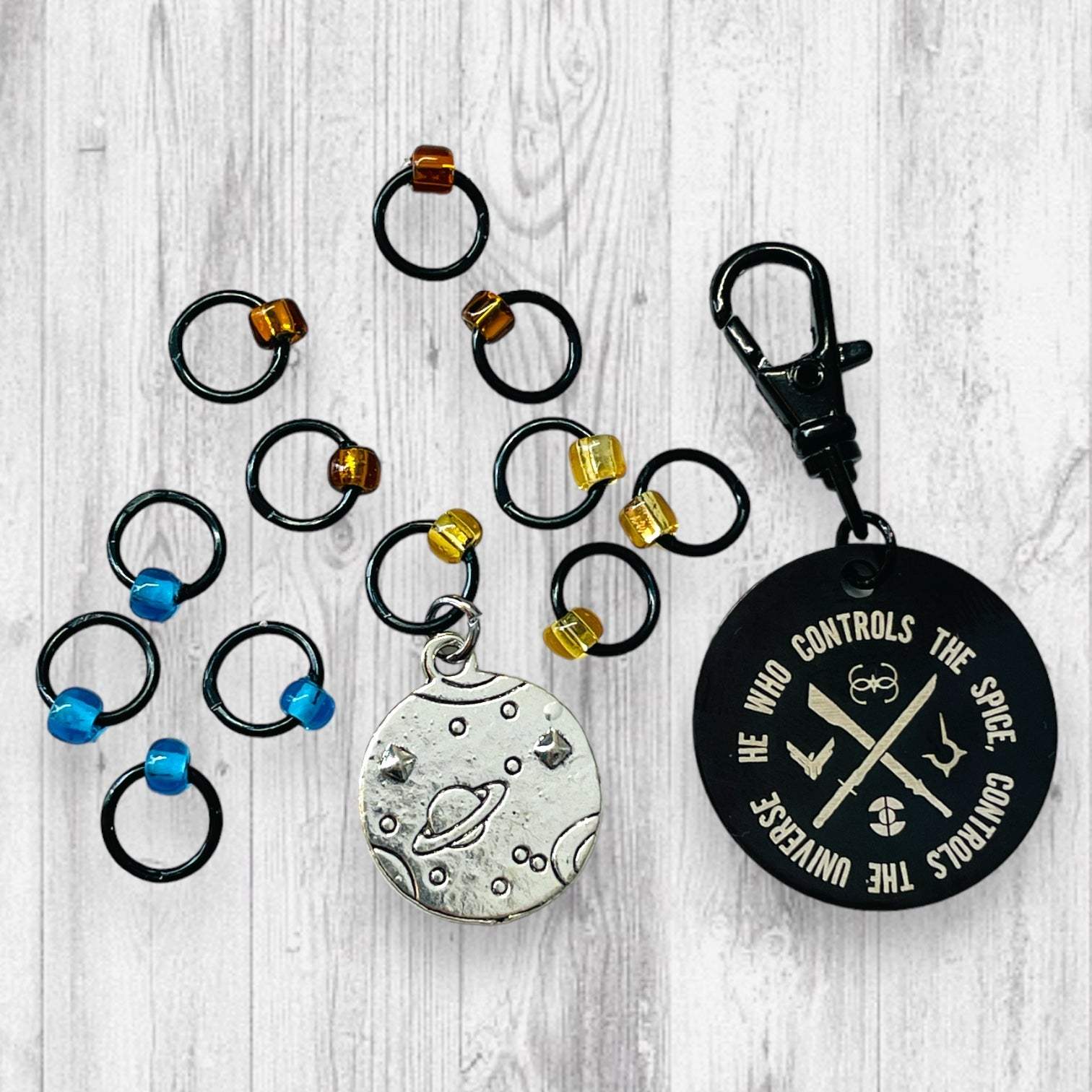 He Who Controls the Spice Progress and Universe Stitch MarkersAdoreKnitHe Who Controls the Spice Progress and Stitch Marker Set.  Inspired by the Frank Herbert's classic novel Dune.  1 of 4 marker sets in the Dune Collection created forUniverse Stitch Markers