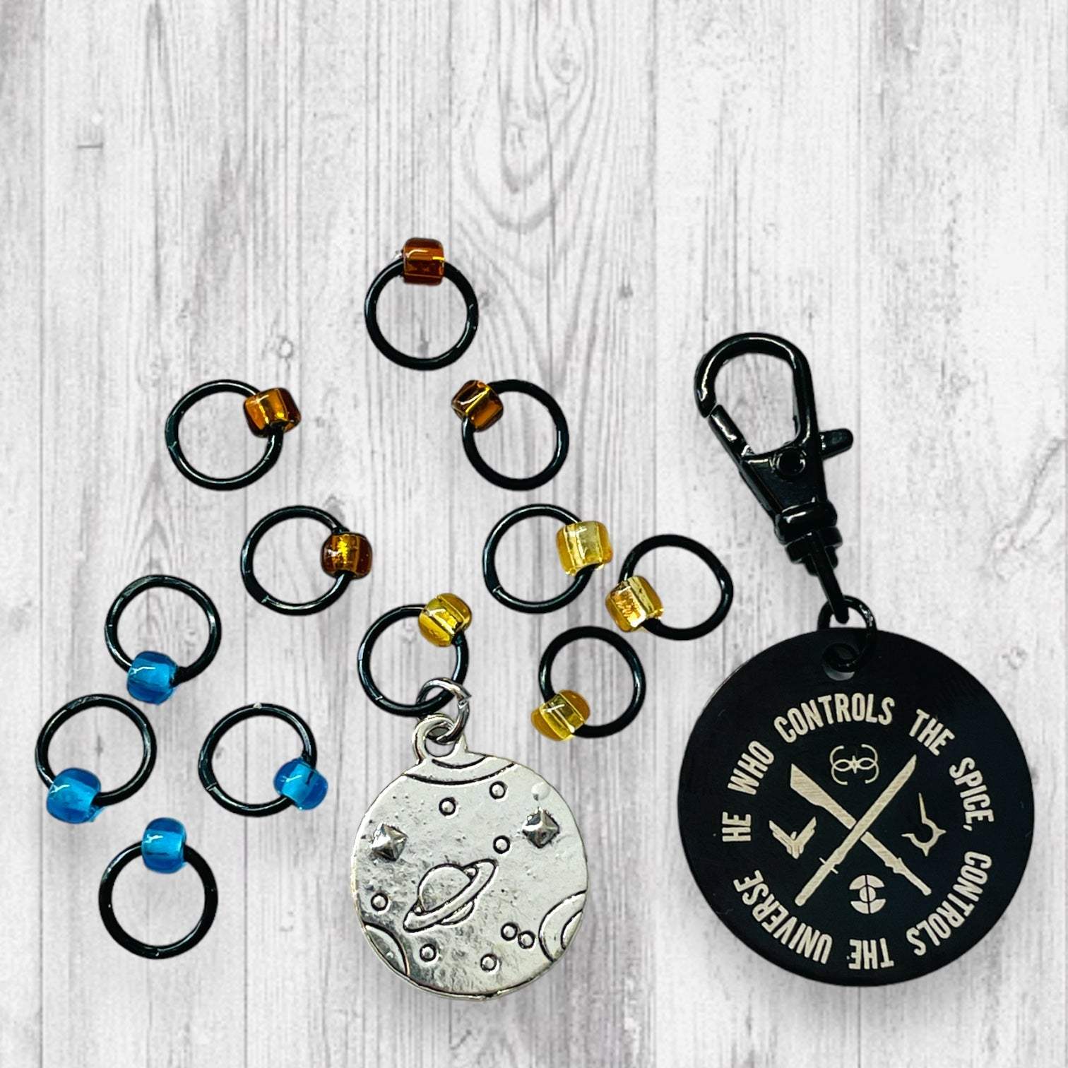 He Who Controls the Spice Progress and Universe Stitch MarkersAdoreKnitHe Who Controls the Spice Progress and Stitch Marker Set.  Inspired by the Frank Herbert's classic novel Dune.  1 of 4 marker sets in the Dune Collection created forUniverse Stitch Markers
