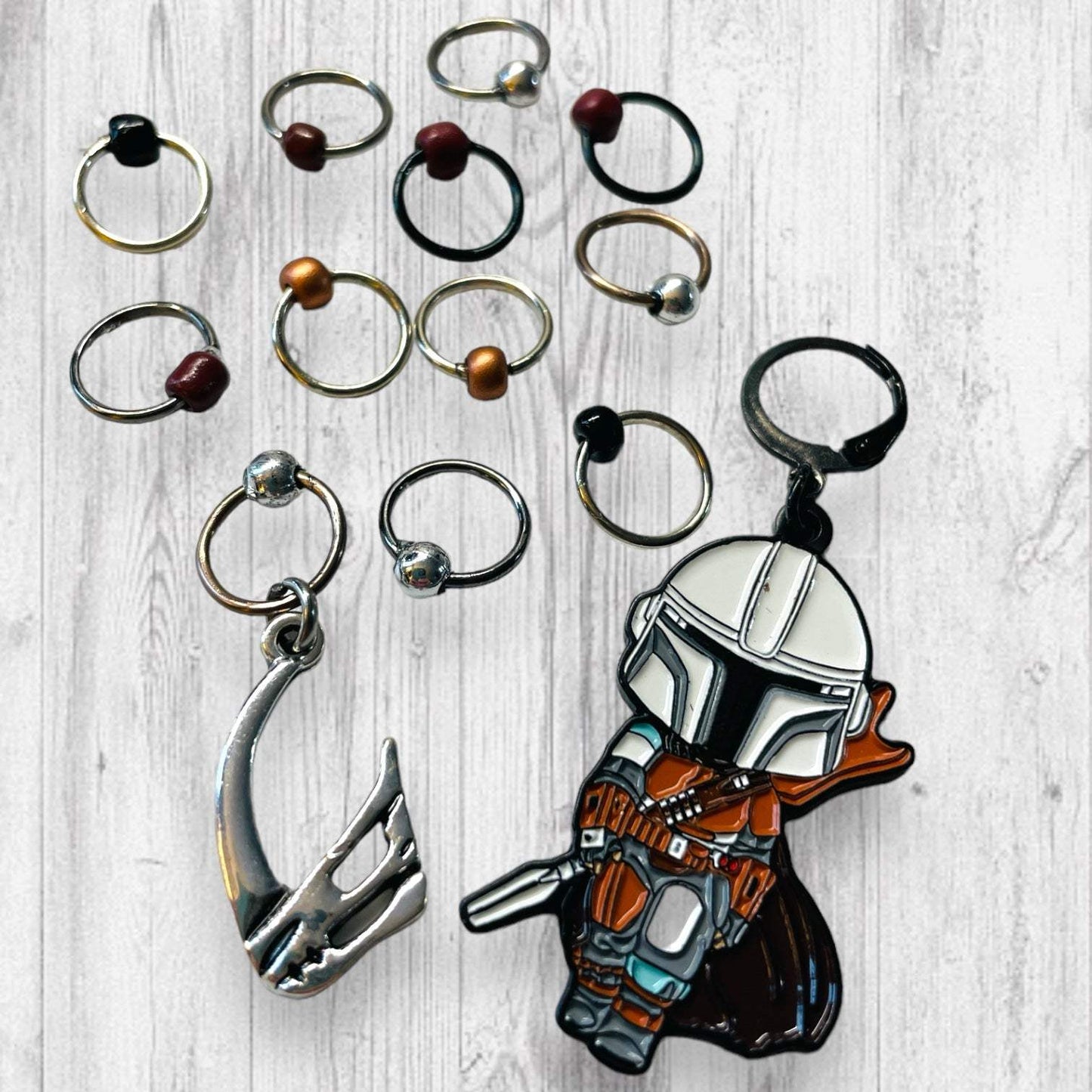 Next Generation Bounty Hunter Progress and Stitch MarkersAdoreKnitNext Generation Bounty Hunter Progress and Stitch Markers. Inspired by The Mandalorian, Din Djarin from the Mandalorian Series.  The prefect gift for a knitter! ThesGeneration Bounty Hunter Progress