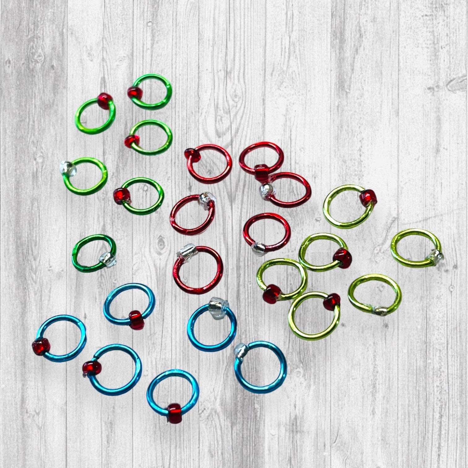 Christmas Sock Knitter's Companion Tiny Stitch Markers with Marker ConAdoreKnitThe Christmas Sock Knitter's Companion!! These tiny stitch markers are perfect for sock knitters. Designed to fit needle sizes: 0-1 US (2-2.5mm). This little set is Companion Tiny Stitch Markers