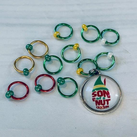 Son of a Nutcracker! Progress and Stitch MarkersAdoreKnit"Son of A Nutcracker" or "Santa OMG I Know Him!” Stitch Markers and Progress Marker. Based on the beloved 2003 movie with Buddy the Elf. Great for your holiday knittStitch Markers