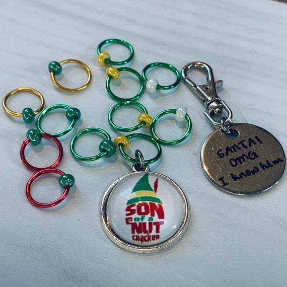 Son of a Nutcracker! Progress and Stitch MarkersAdoreKnit"Son of A Nutcracker" or "Santa OMG I Know Him!” Stitch Markers and Progress Marker. Based on the beloved 2003 movie with Buddy the Elf. Great for your holiday knittStitch Markers