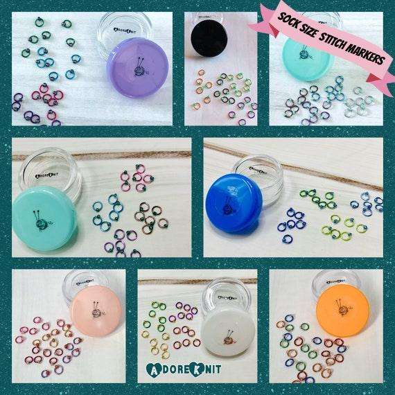 Christmas Sock Knitter's Companion Tiny Stitch Markers with Marker ConAdoreKnitThe Christmas Sock Knitter's Companion!! These tiny stitch markers are perfect for sock knitters. Designed to fit needle sizes: 0-1 US (2-2.5mm). This little set is Companion Tiny Stitch Markers