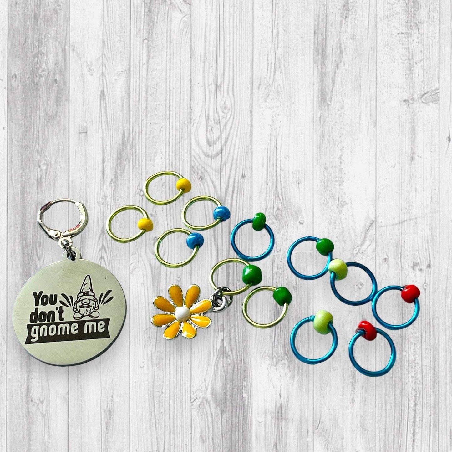 You Don't Gnome Me Progress and Stitch MarkersAdoreKnitYou Don't Gnome Me Progress and Stitch Markers. We couldn't decide if the Gnome house or the daisy went better for this set, so you decide!  Both match perfectly witStitch Markers