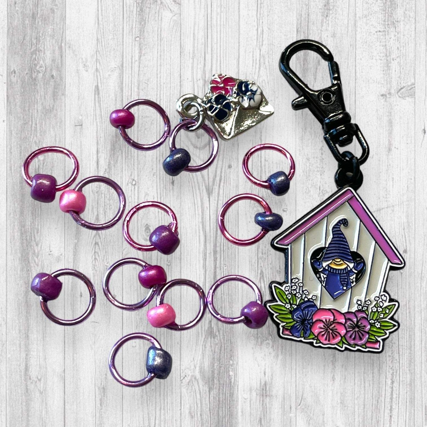 Gnome Place like Home Purple Pansies Progress and Stitch MarkersAdoreKnitAdoreKnit EXCLUSIVE! Gnome Place like Home with Purple Pansies Progress and Stitch Markers. For the longest time I didn't know what girl Gnomes looked like.  This laHome Purple Pansies Progress