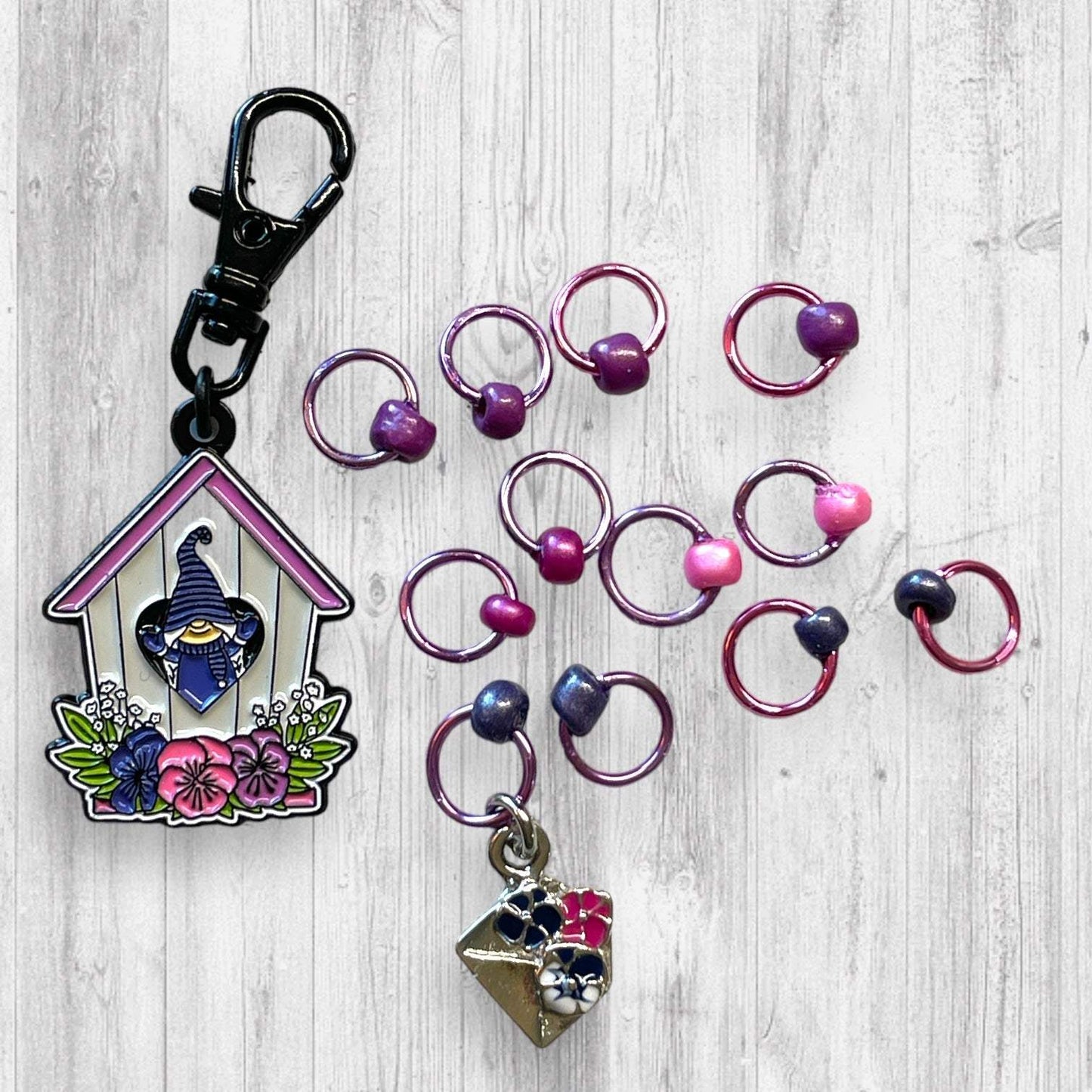 Gnome Place like Home Purple Pansies Progress and Stitch MarkersAdoreKnitAdoreKnit EXCLUSIVE! Gnome Place like Home with Purple Pansies Progress and Stitch Markers. For the longest time I didn't know what girl Gnomes looked like.  This laHome Purple Pansies Progress