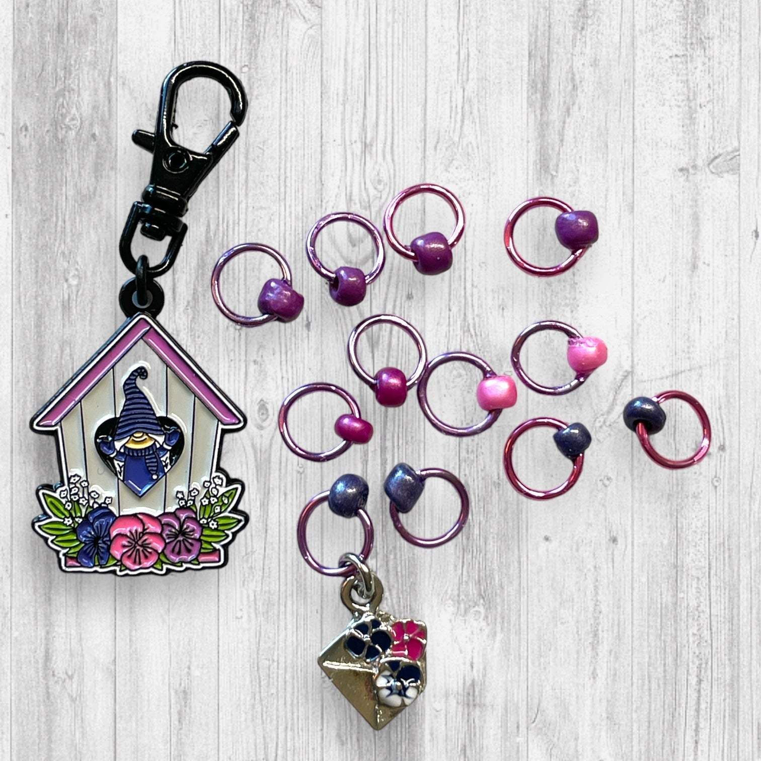 Gnome Place like Home Purple Pansies Progress and Stitch MarkersAdoreKnitAdoreKnit EXCLUSIVE! Gnome Place like Home with Purple Pansies Progress and Stitch Markers. For the longest time I didn't know what girl Gnomes looked like.  This laHome Purple Pansies Progress