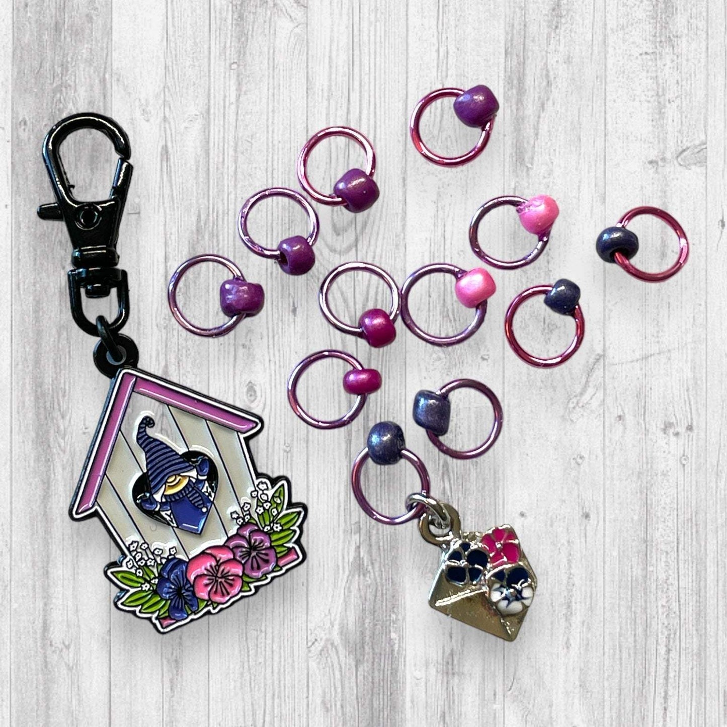 Gnome Place like Home Purple Pansies Progress and Stitch MarkersAdoreKnitAdoreKnit EXCLUSIVE! Gnome Place like Home with Purple Pansies Progress and Stitch Markers. For the longest time I didn't know what girl Gnomes looked like.  This laHome Purple Pansies Progress