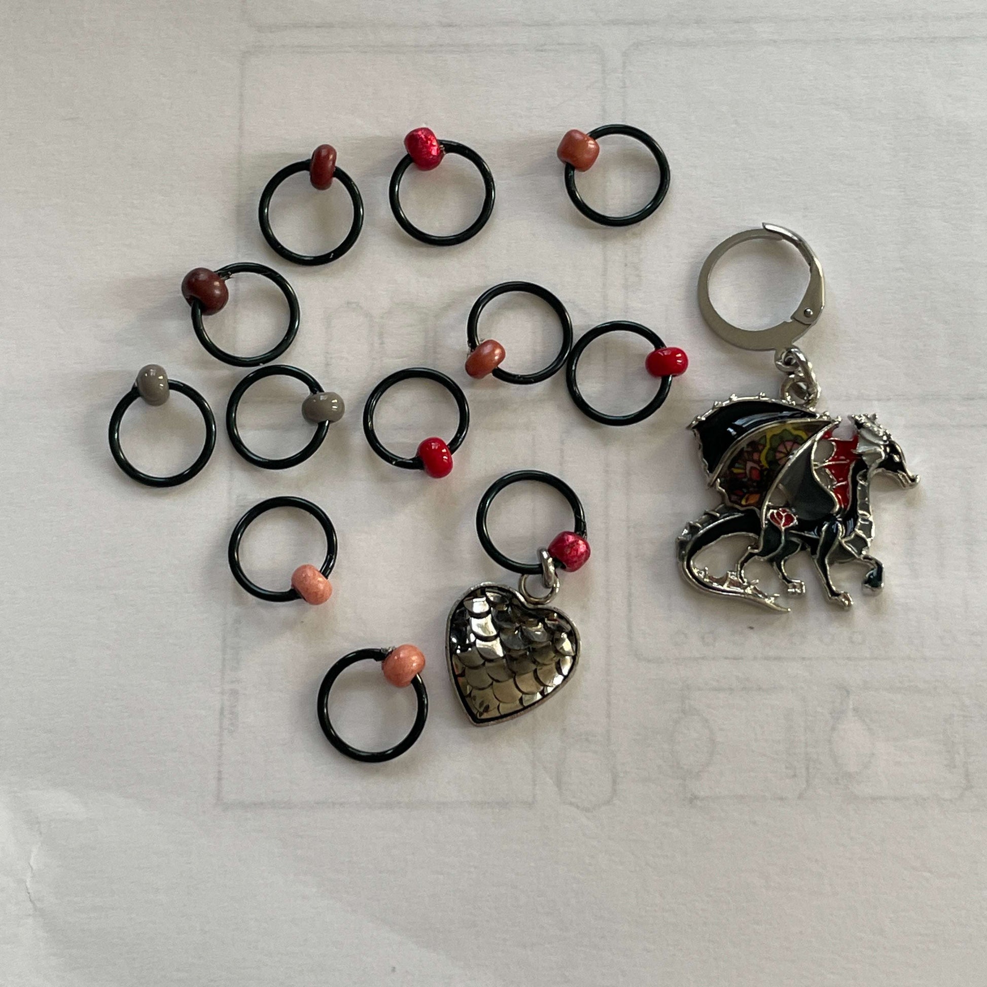 Fire Will Reign Progress and Stitch MarkersAdoreKnit“It has been said that dragon-fire could melt and consume the Rings of Power, but there is not now any dragon left on earth in which the old fire is hot enough; nor Reign Progress