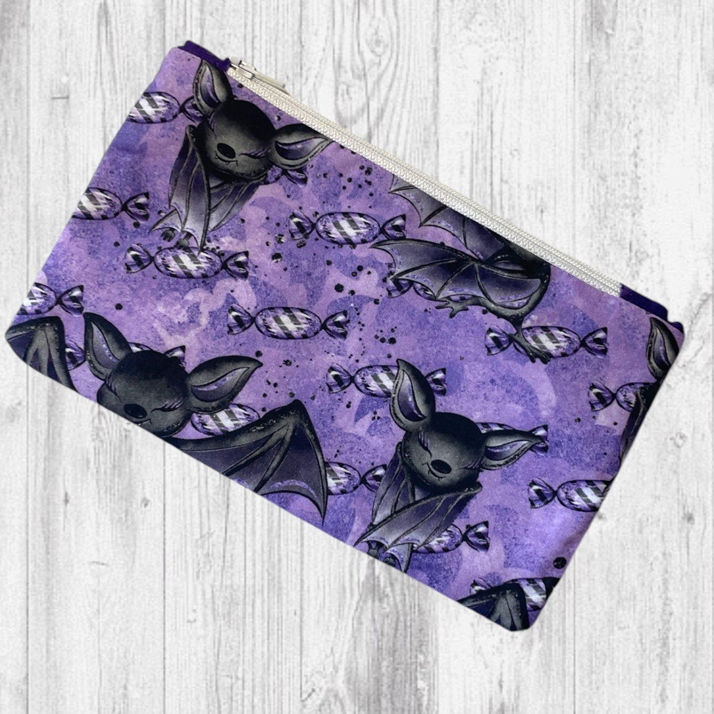 Playful Purple Bats Pass Piles of Peppermint Candy Notion's Pouch